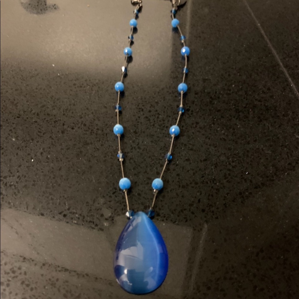 Silver necklace with blue pendant and blue beads